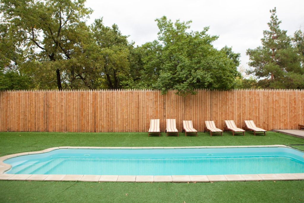 backyard pool with beach chair on the side