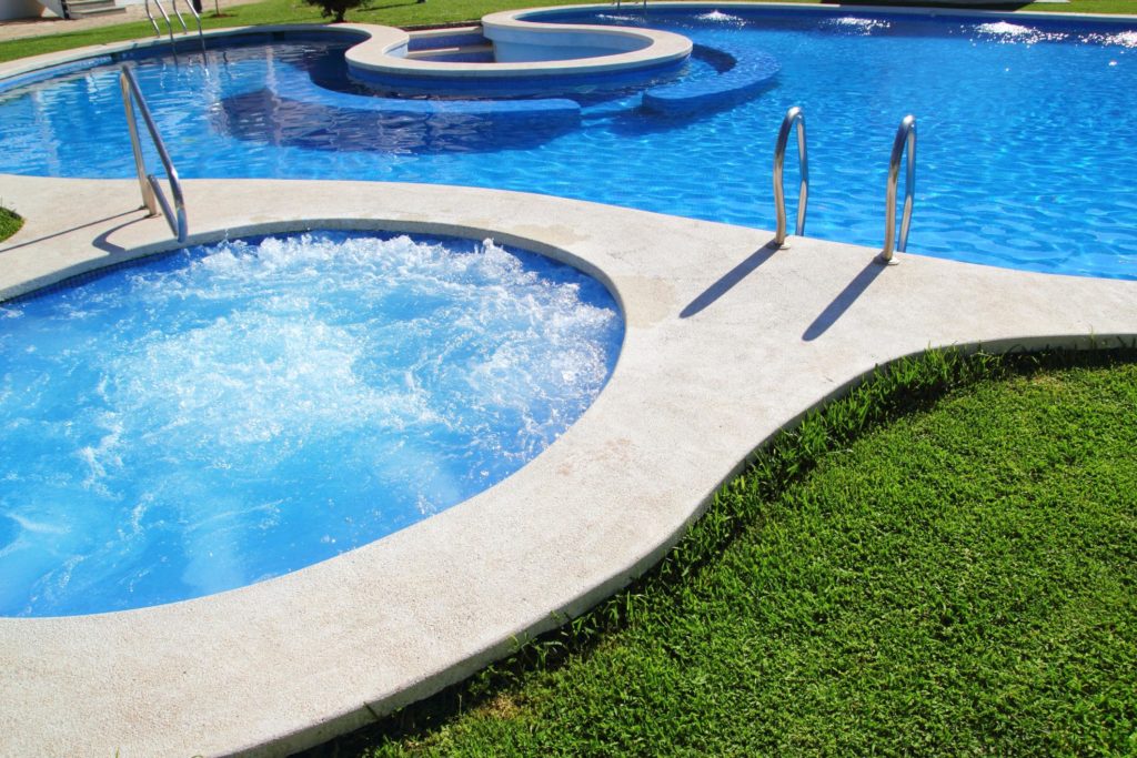 swimming pool with jacuzzi on the side