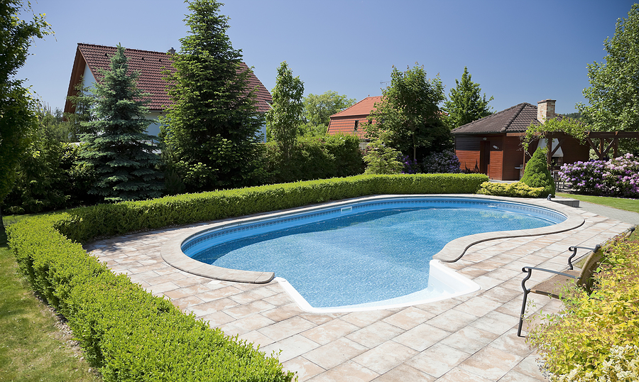 pool with the blue water and deckchair