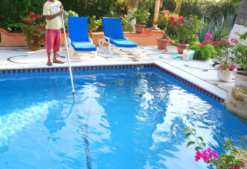 man cleaning the pool